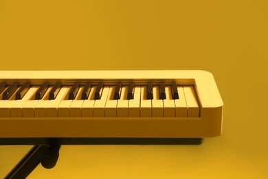 Image of Synthesizer, closeup. Toned in yellow color. Electronic musical instrument