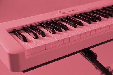 Image of Synthesizer, closeup. Toned in pink color. Electronic musical instrument