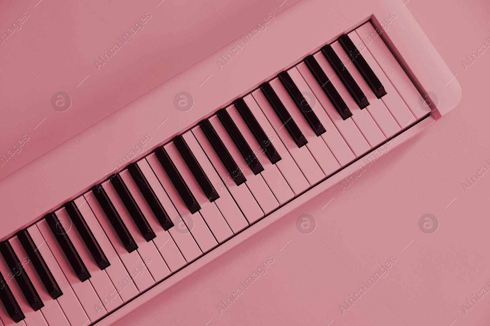 Image of Synthesizer, top view. Toned in pink color. Electronic musical instrument