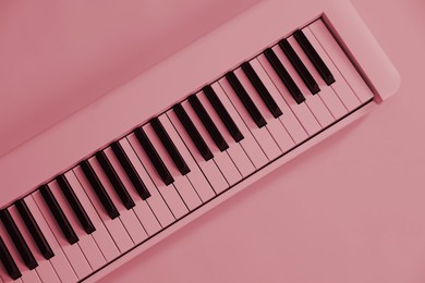 Image of Synthesizer, top view. Toned in pink color. Electronic musical instrument