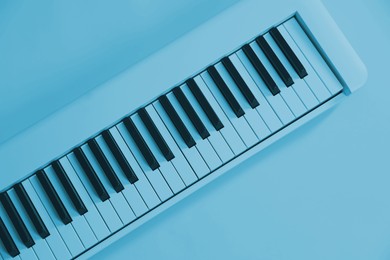 Image of Synthesizer, top view. Toned in light blue color. Electronic musical instrument