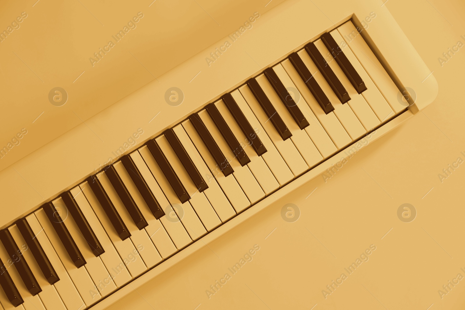 Image of Synthesizer, top view. Toned in yellow color. Electronic musical instrument