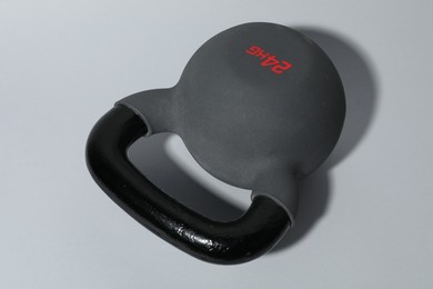 Photo of One metal kettlebell on grey background, closeup. Sports equipment