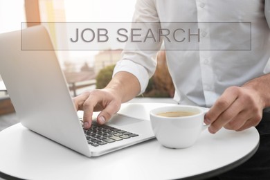 Image of Job Search. Man with laptop and cup of coffee at table, closeup