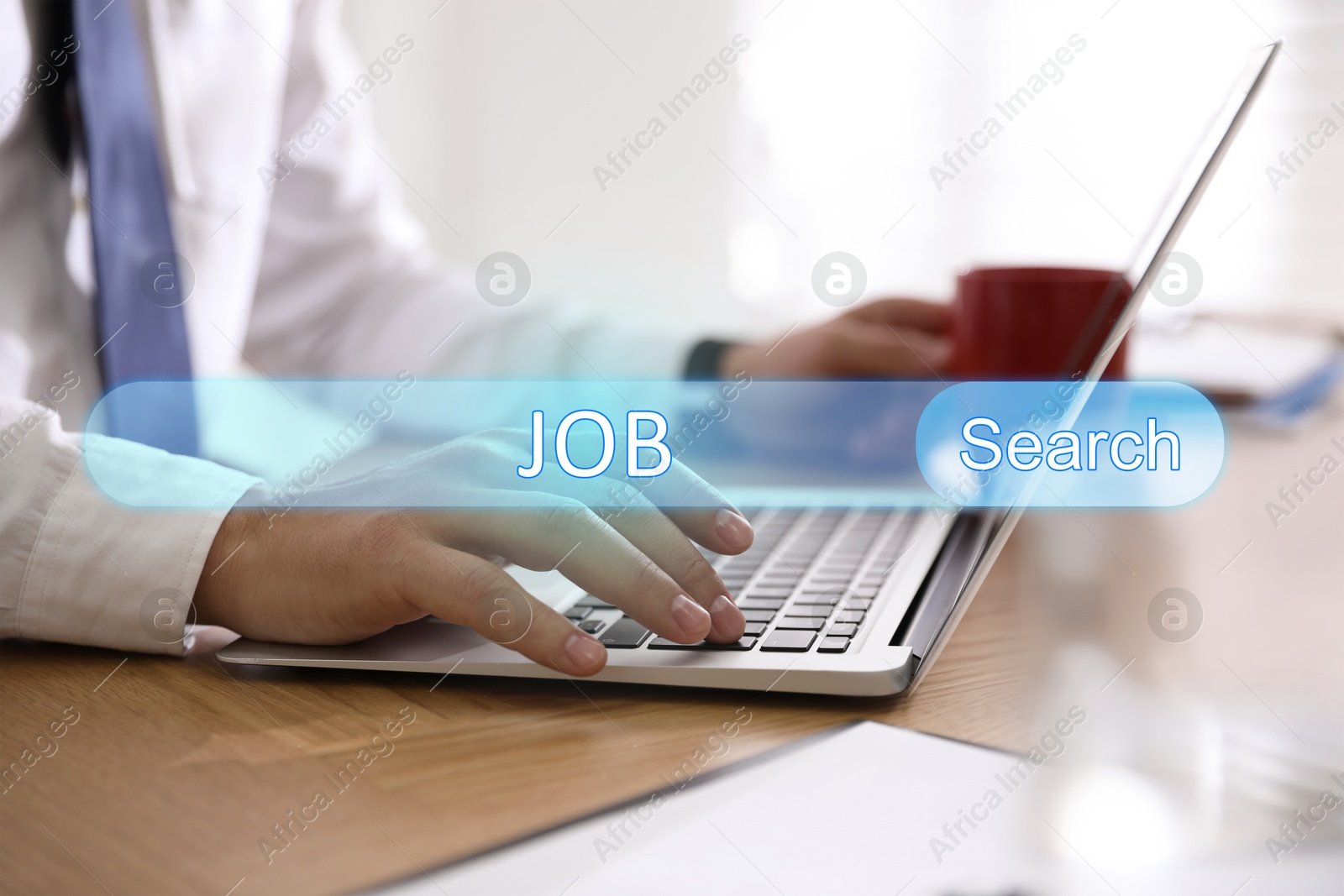 Image of Job Search. Man using laptop at table, closeup. Search bar with words