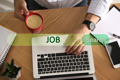 Job Search. Man with laptop and cup of coffee at table, top view. Search bar with words