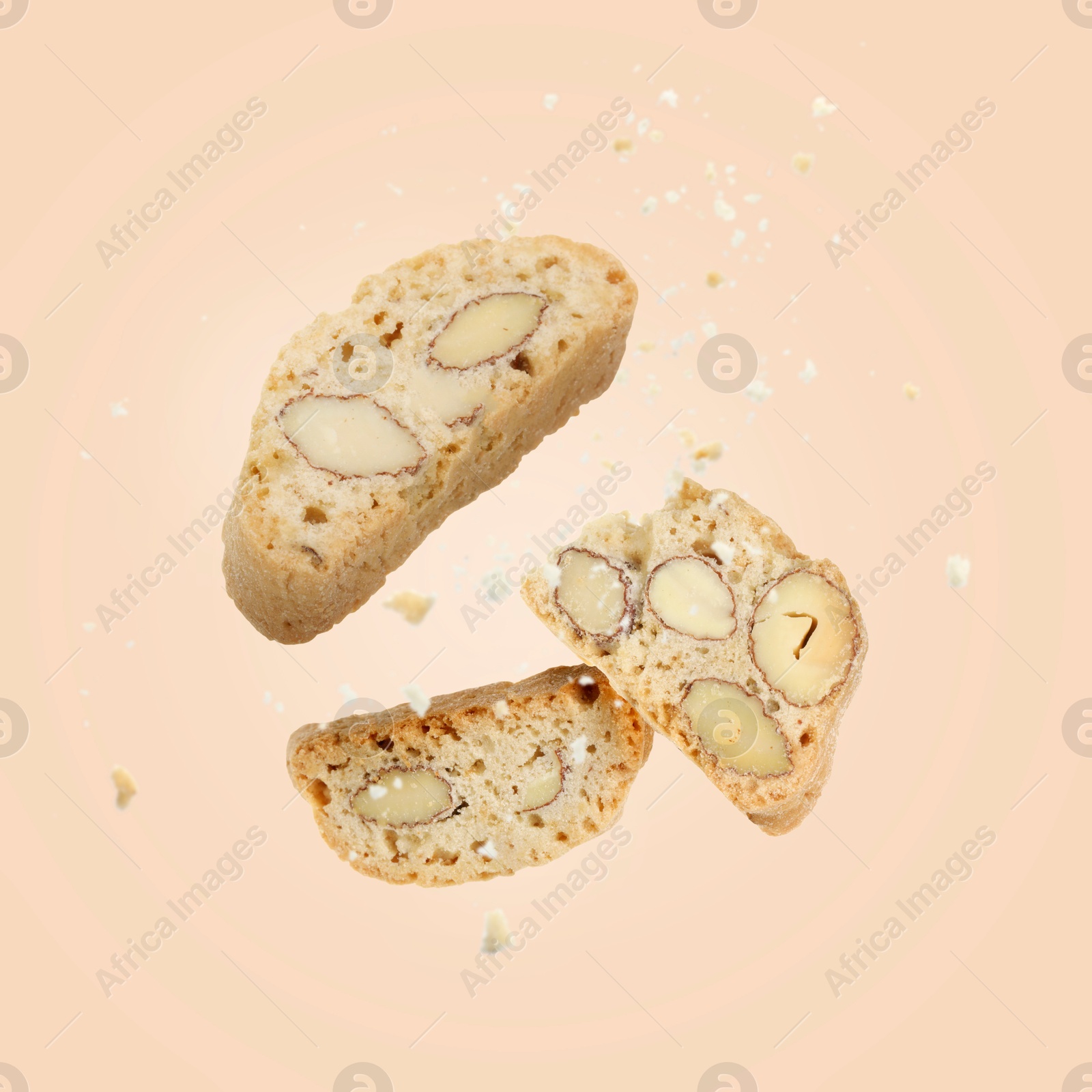 Image of Tasty cookies with almond nuts in air on pink beige background. Traditional Italian Cantuccini