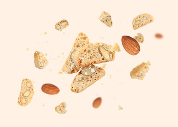 Image of Tasty cookies with almond nuts in air on beige background. Traditional Italian Cantuccini