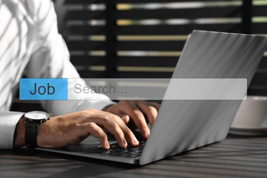 Image of Job Search. Man using laptop at table, closeup. Search bar with words