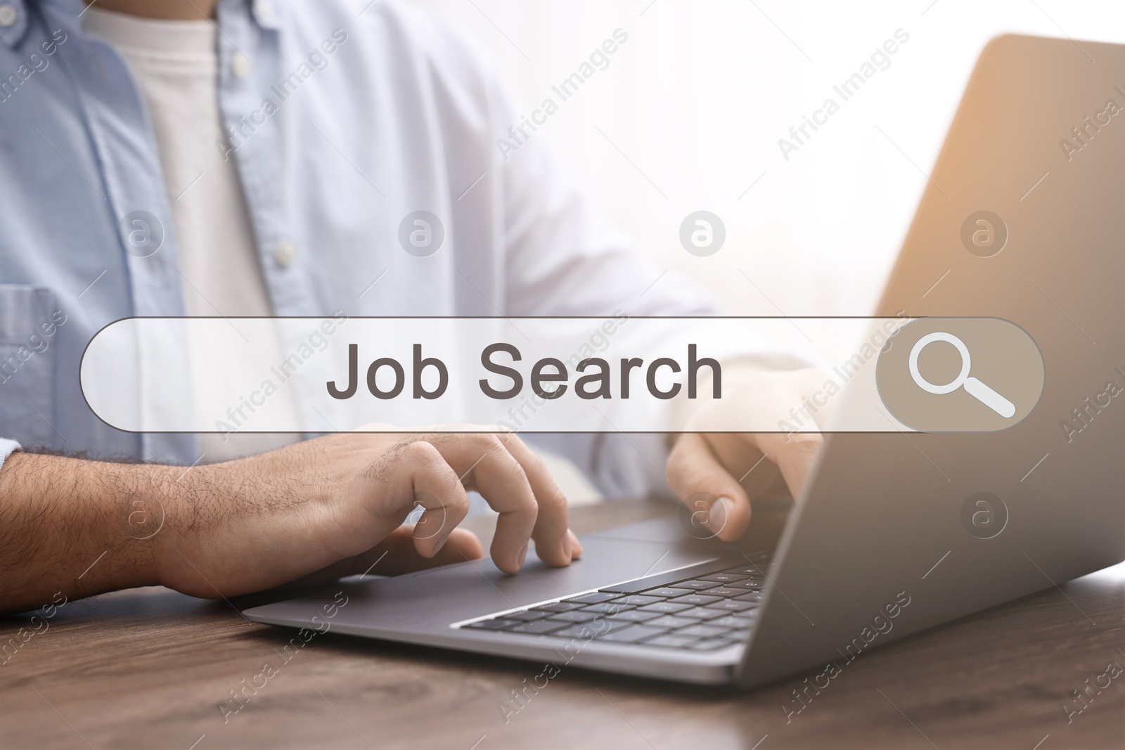 Image of Job Search. Man using laptop at table, closeup. Search bar with words