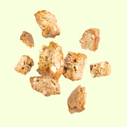 Image of Tasty cookies with almond nuts in air on pastel green background. Traditional Italian Cantuccini