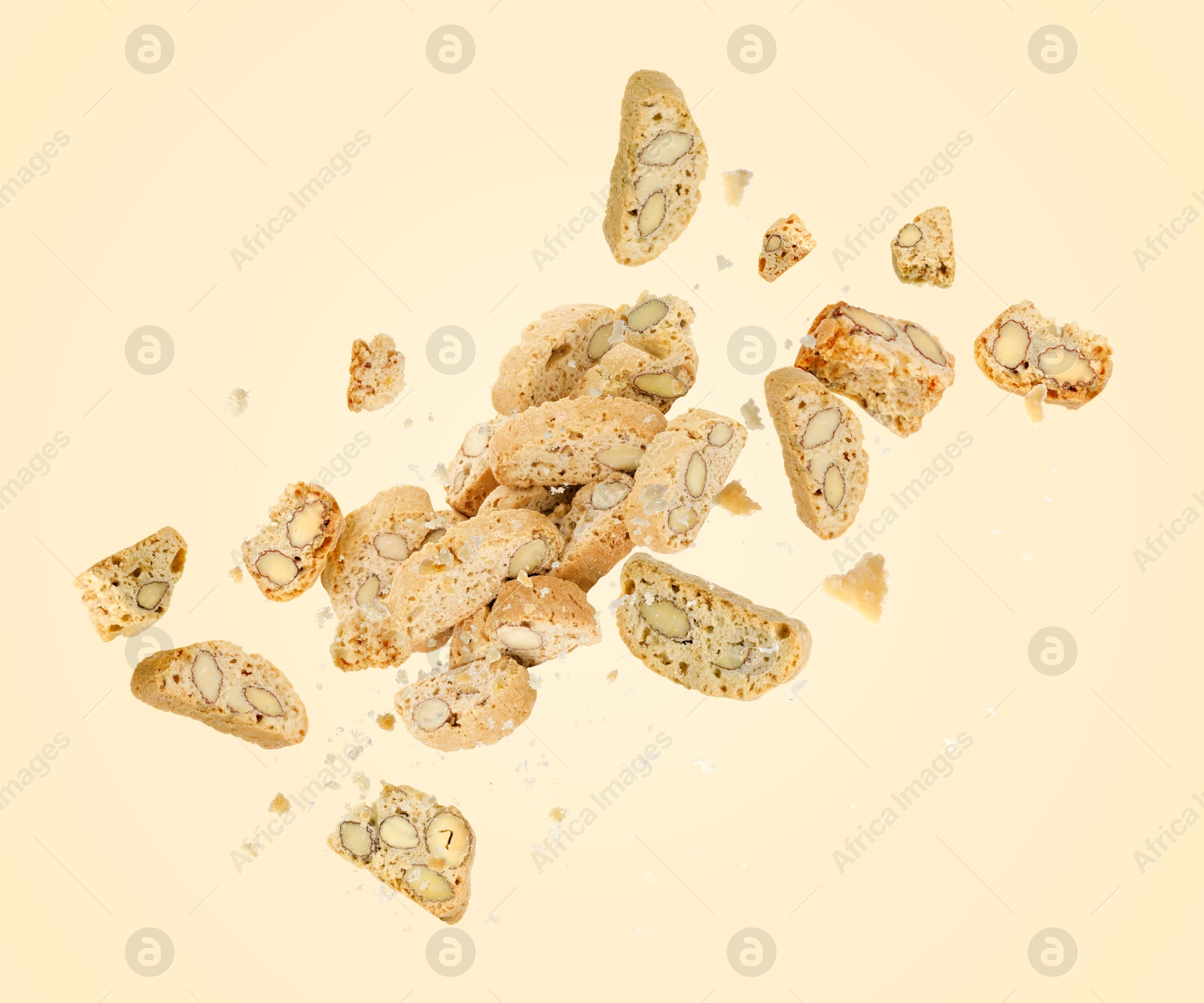 Image of Tasty cookies with almond nuts in air on beige background. Traditional Italian Cantuccini