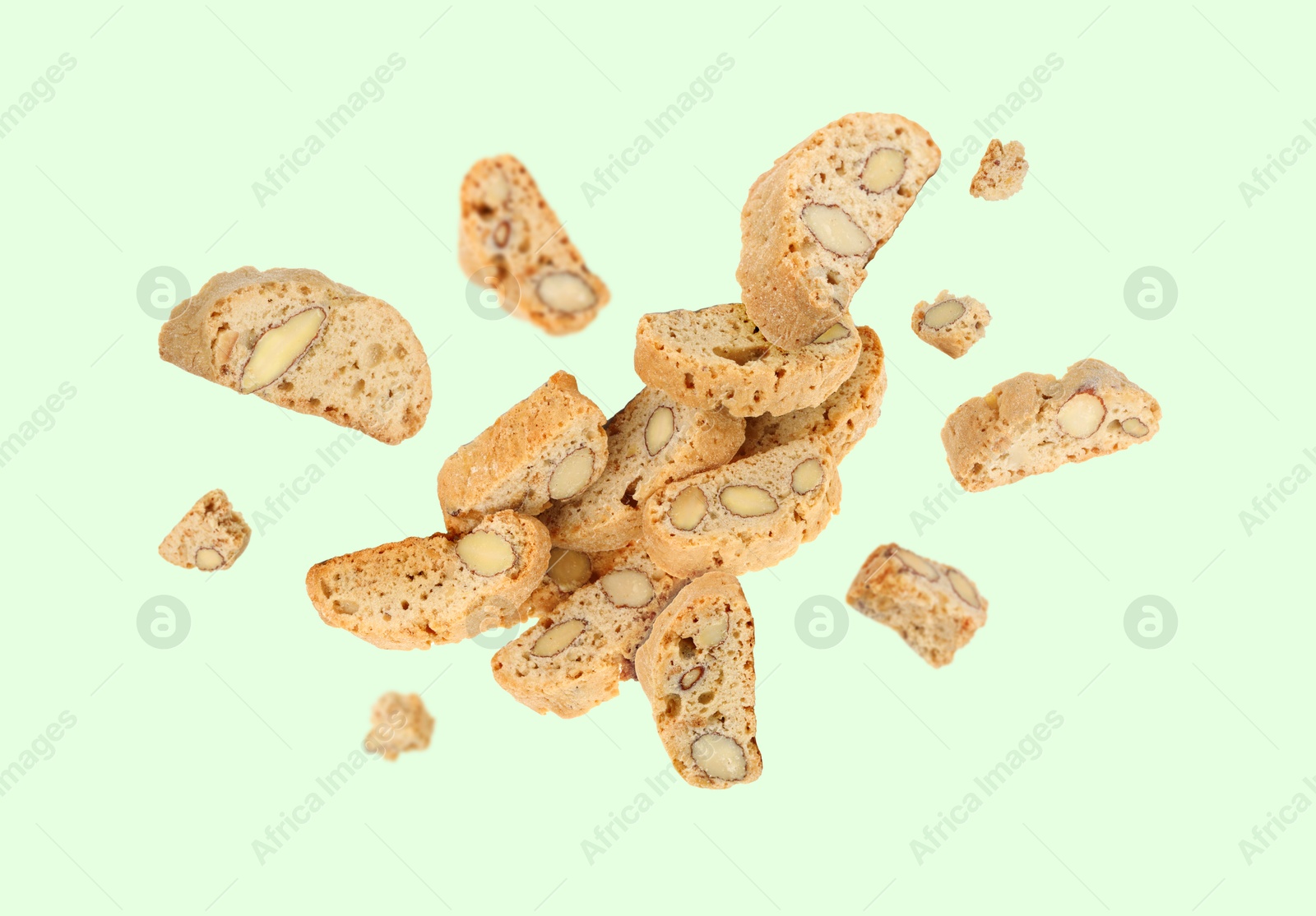 Image of Tasty cookies with almond nuts in air on pastel green background. Traditional Italian Cantuccini