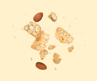 Image of Tasty cookies with almond nuts in air on beige background. Traditional Italian Cantuccini