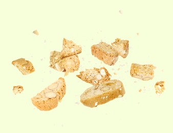 Image of Tasty cookies with almond nuts in air on pastel green background. Traditional Italian Cantuccini