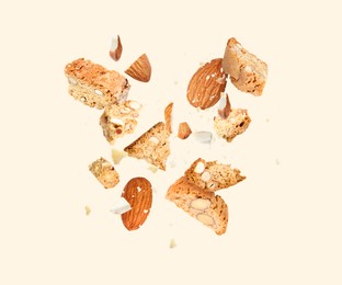 Image of Tasty cookies with almond nuts in air on beige background. Traditional Italian Cantuccini