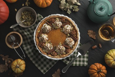 Photo of Flat lay composition with homemade pumpkin pie on black table