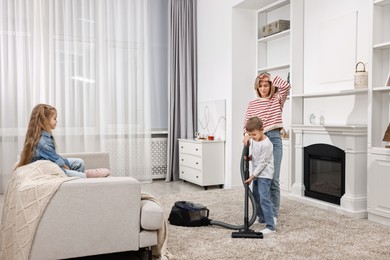 Housewife and her kids cleaning room together