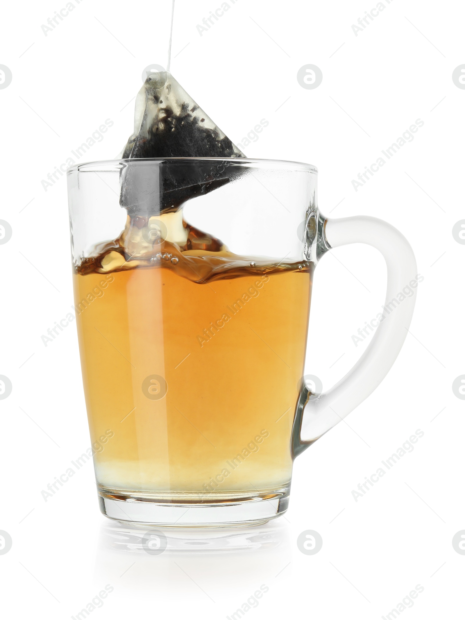 Photo of Brewing aromatic tea. Cup with teabag isolated on white