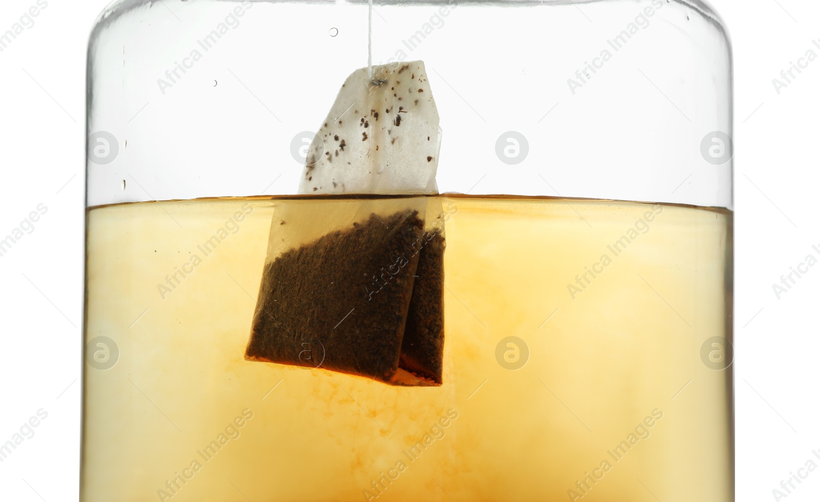 Photo of Putting tea bag into glass cup on white background, closeup