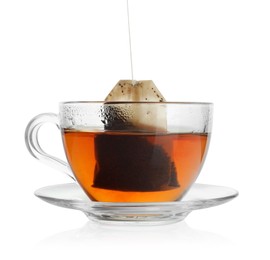 Photo of Putting tea bag into glass cup on white background