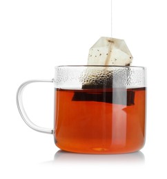 Photo of Putting tea bag into glass cup on white background