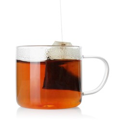 Photo of Putting tea bag into glass cup on white background