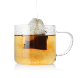 Photo of Putting tea bag into glass cup on white background