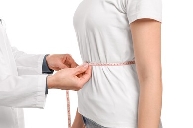 Photo of Weight loss. Nutritionist measuring patient's waist with tape on white background, closeup