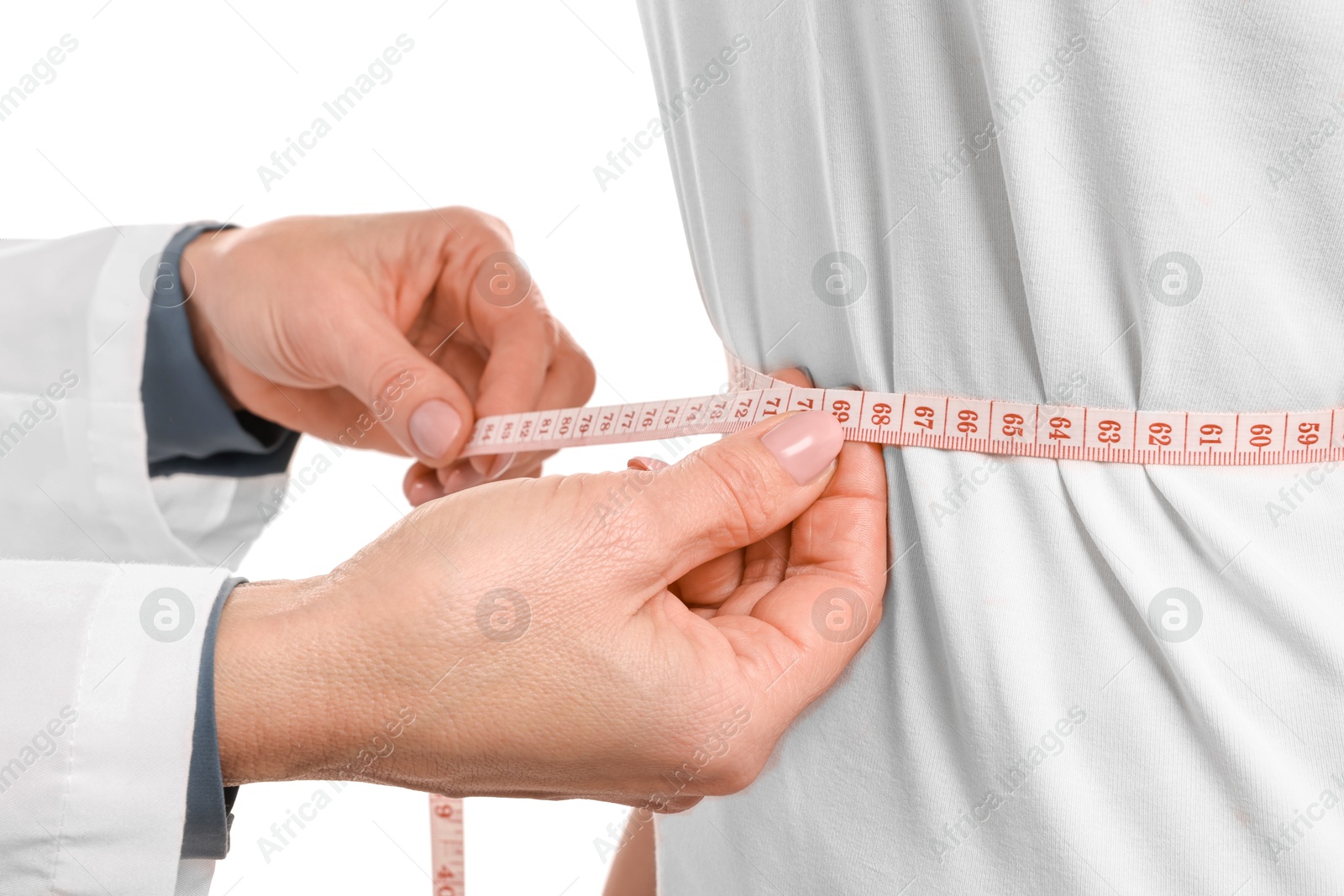 Photo of Weight loss. Nutritionist measuring patient's waist with tape on white background, closeup