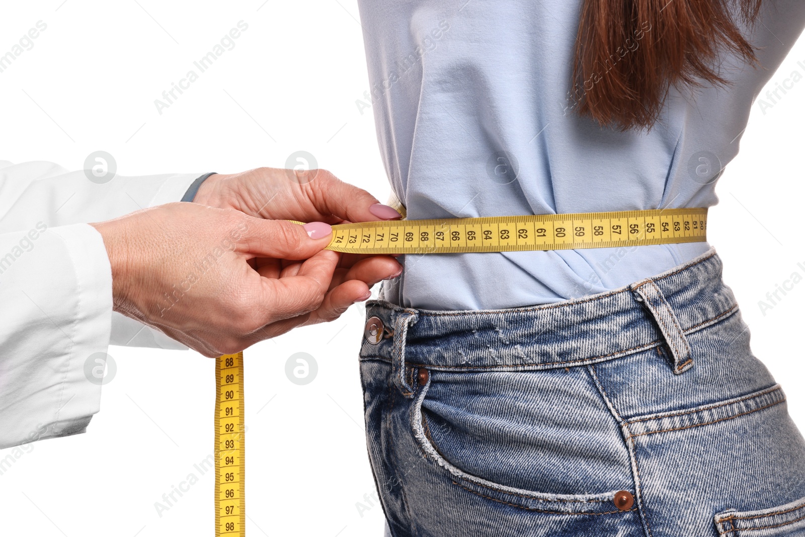 Photo of Weight loss. Nutritionist measuring patient's waist with tape on white background, closeup