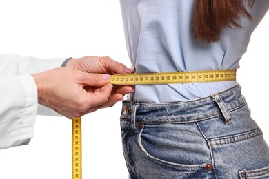 Photo of Weight loss. Nutritionist measuring patient's waist with tape on white background, closeup