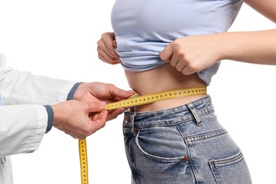 Photo of Weight loss. Nutritionist measuring patient's waist with tape on white background, closeup