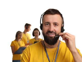 Technical support call center. Smiling operator on white background, selective focus