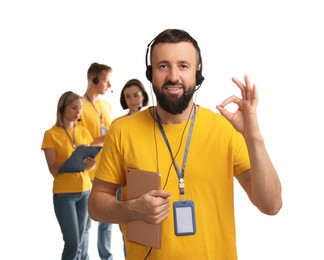 Photo of Technical support call center. Team of friendly operators on white background