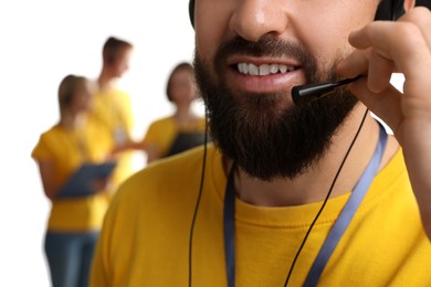 Photo of Technical support call center. Smiling operator on white background, closeup