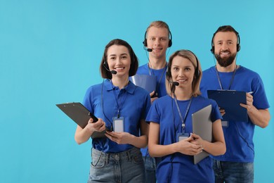 Technical support call center. Team of friendly operators on light blue background