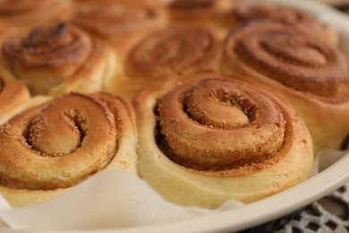 Photo of Freshly baked cinnamon rolls in baking dish, closeup