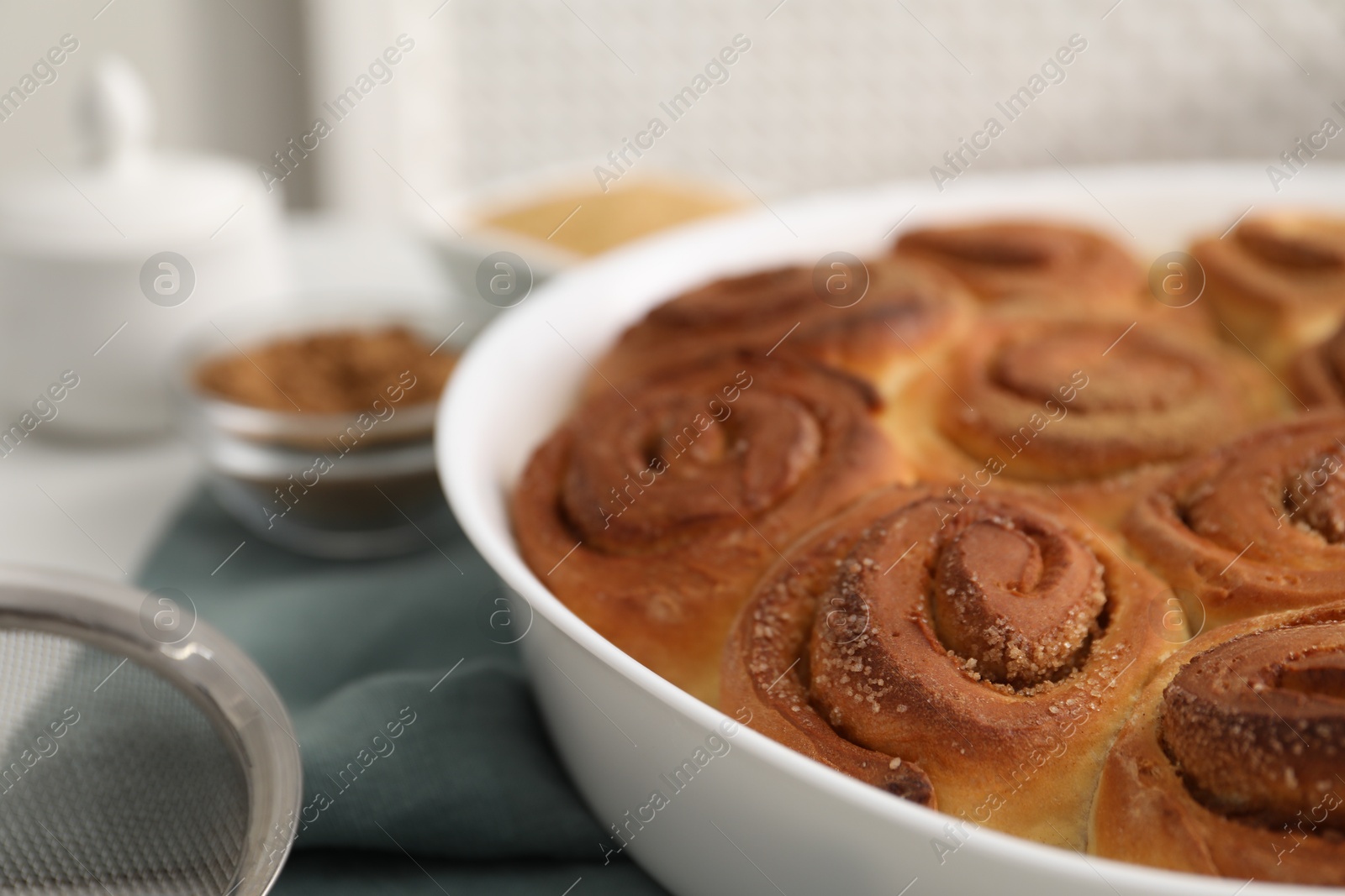 Photo of Freshly baked cinnamon rolls on table, closeup