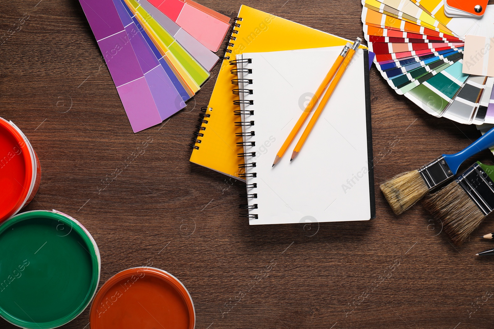 Photo of Flat lay composition with different painter's tools on wooden table. Decorating and design