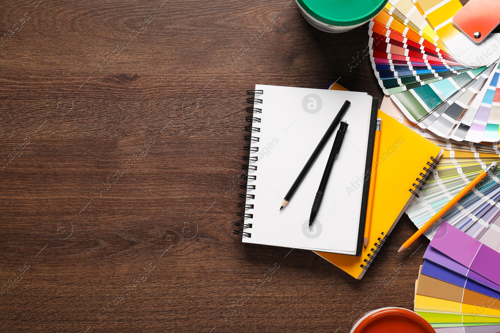 Photo of Flat lay composition with different painter's tools on wooden table, space for text. Decorating and design