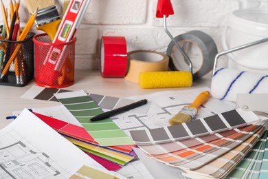 Photo of Different painter's tools on table. Decorating and design