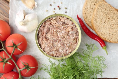 Photo of Canned meat in tin can served on table, flat lay