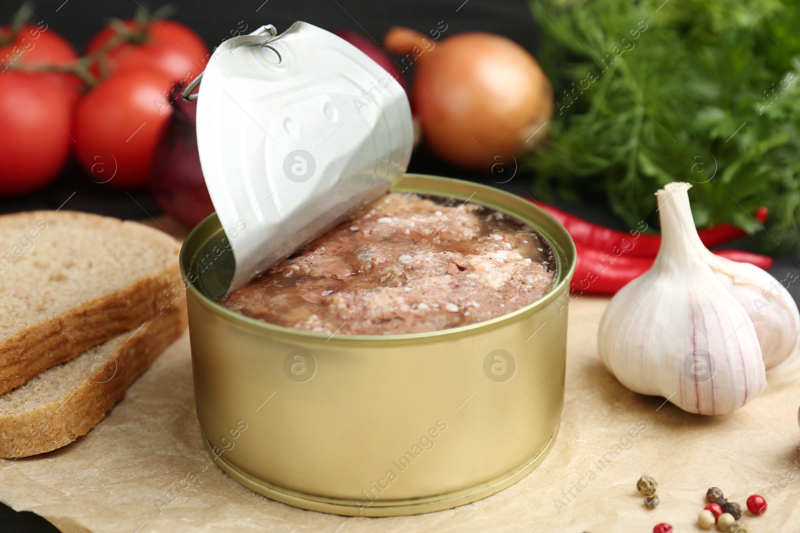 Photo of Canned meat in tin can and other products on table, closeup