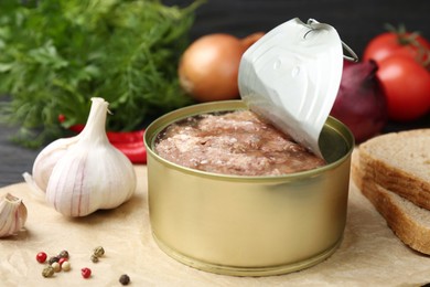 Photo of Canned meat in tin can and other products on table, closeup