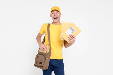 Happy postman with bag and envelopes on white background