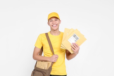 Photo of Happy postman with bag and envelopes on white background