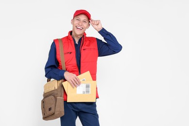 Photo of Happy postman with envelopes on white background. Space for text