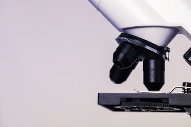 Photo of Science. Modern microscope on light grey background, closeup. Space for text