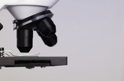 Photo of Science. Modern microscope on light grey background, closeup. Space for text